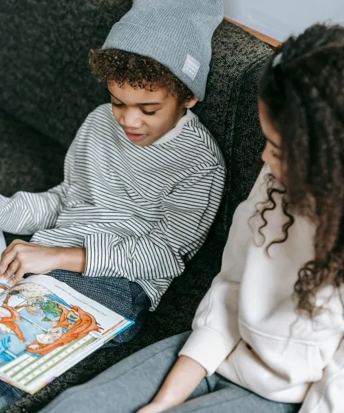 Children reading a book together